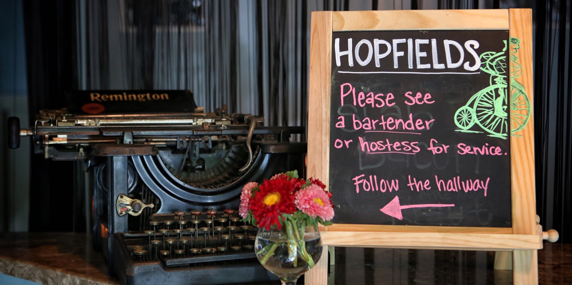 The Hopfields host stand with a vintage typewriter