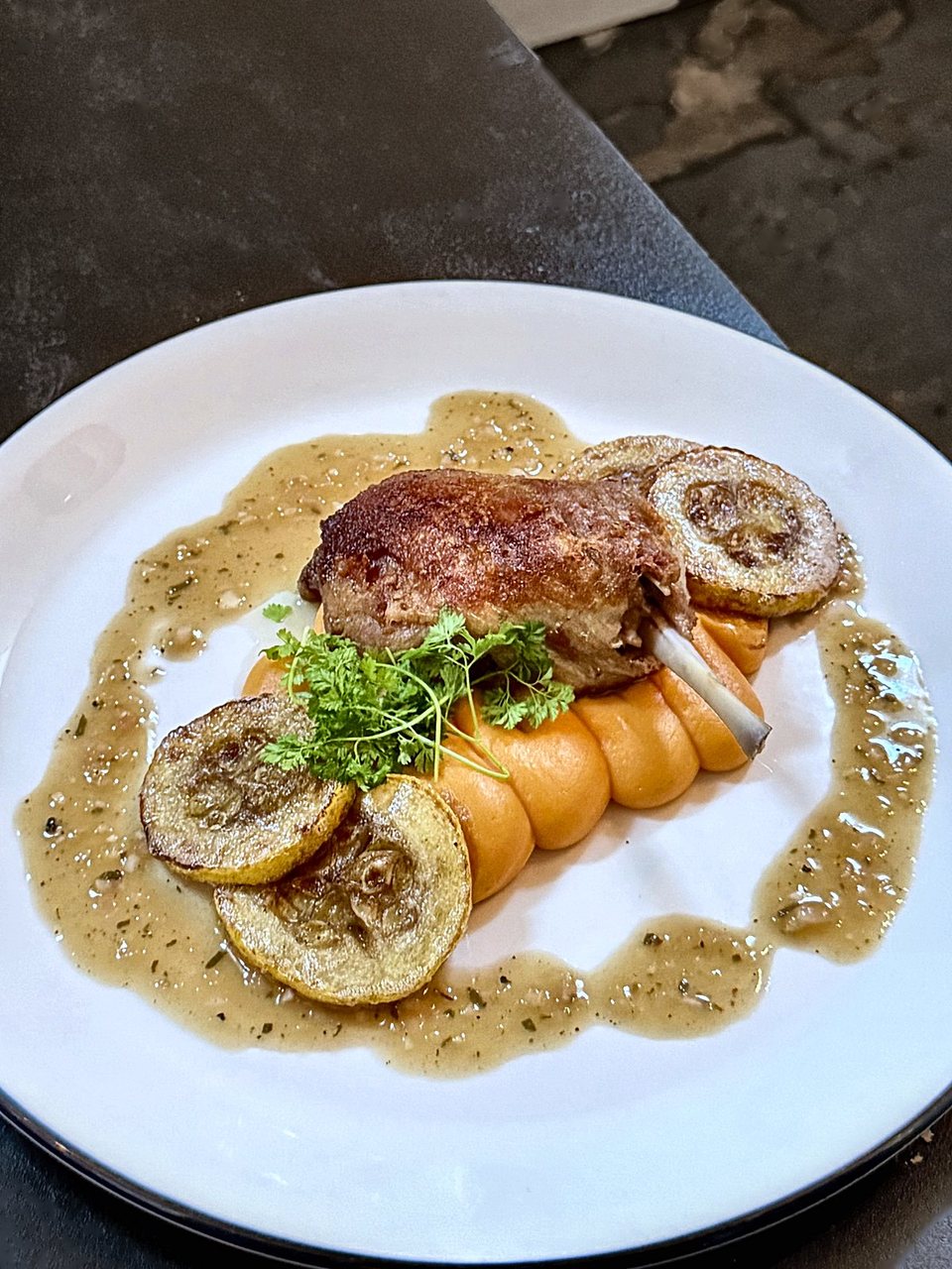 Duck confit at Hopfields: crisp duck leg over sweet potato purée with seared yellow squash and sage brown butter vinaigrette