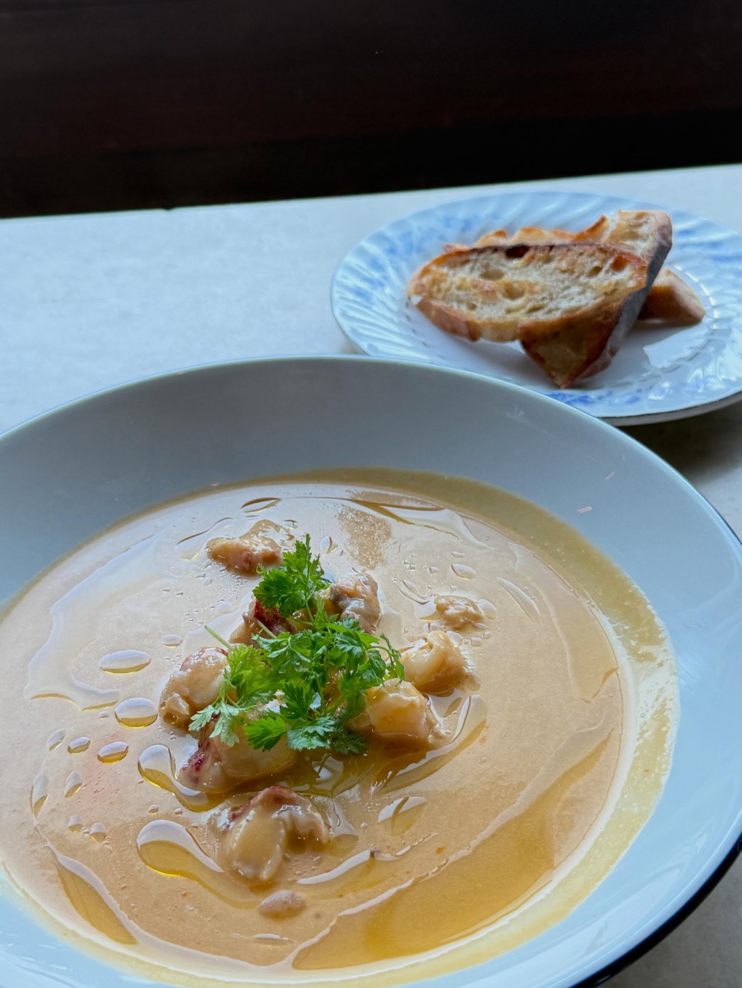 Classic lobster bisque at Hopfields with chervil, and baguette on the side