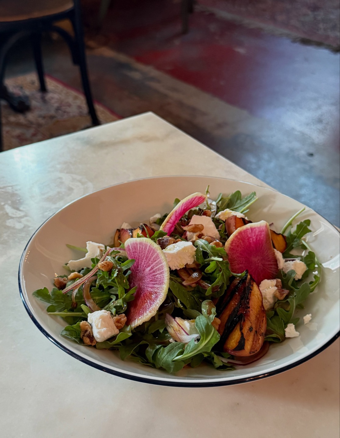Grilled peach salad at Hopfields with arugula, chèvre, walnuts and watermelon radish